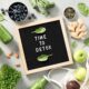 Healthy foods surrounding a sign that reads Time to Detox